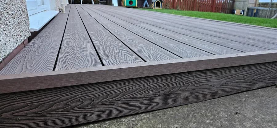 Composite decking boards installed on recycled plastic subframe joists