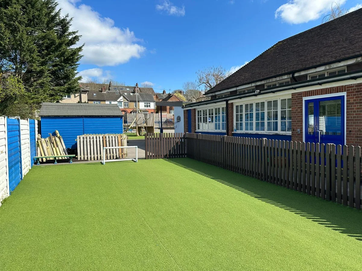 Dark charcoal recycled plastic picket fence alongside school building